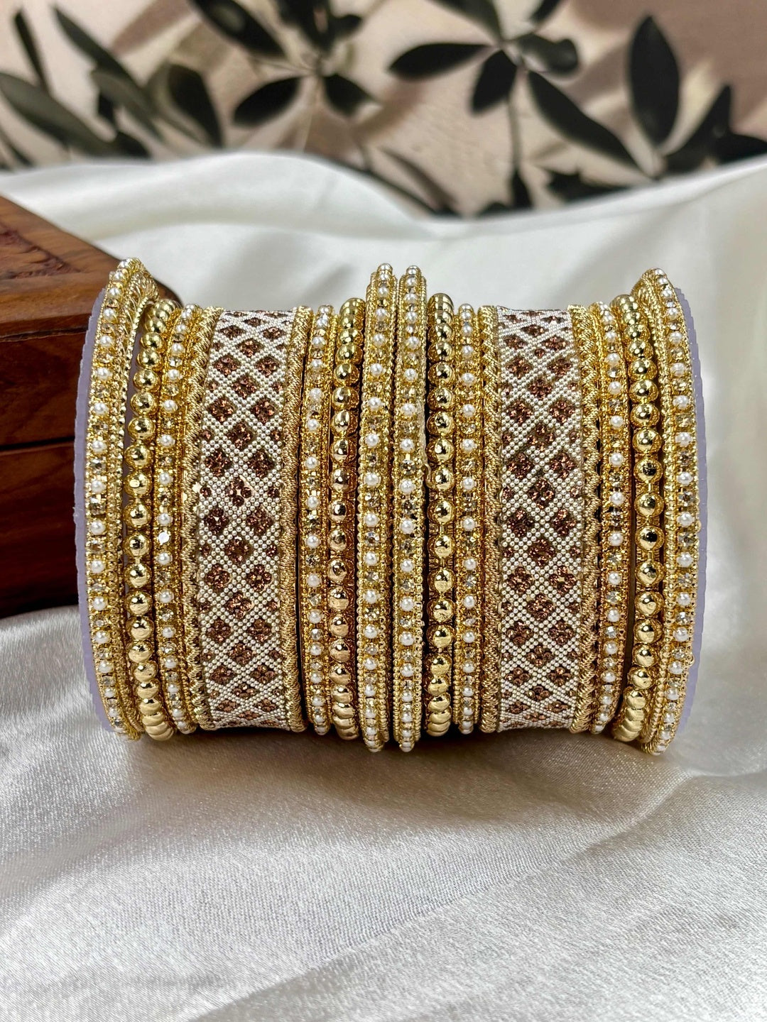 Ishhaara Gold Plated Kundan Bangle Set - a stack of intricately designed gold bangles with stone embellishments