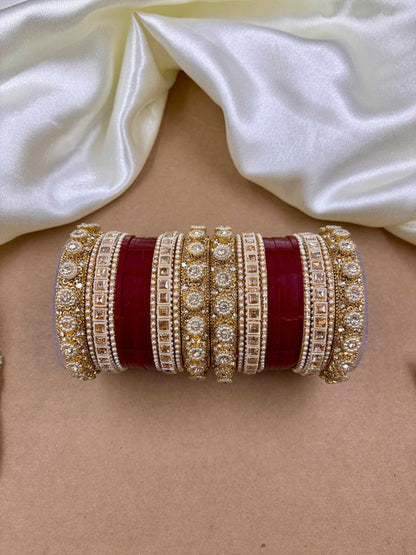 Ishhaara Handcrafted Kundan Bangles Set - a stack of intricately designed bangles with red glass center - view 3