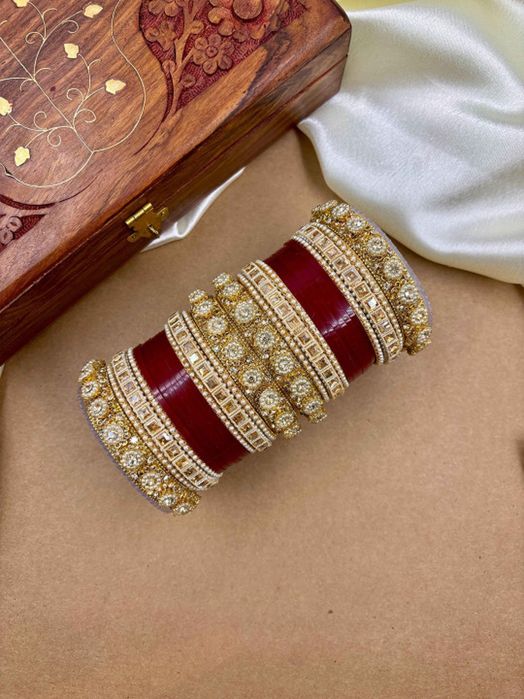 Ishhaara Handcrafted Kundan Bangles Set - a stack of intricately designed bangles with red glass center - view 7