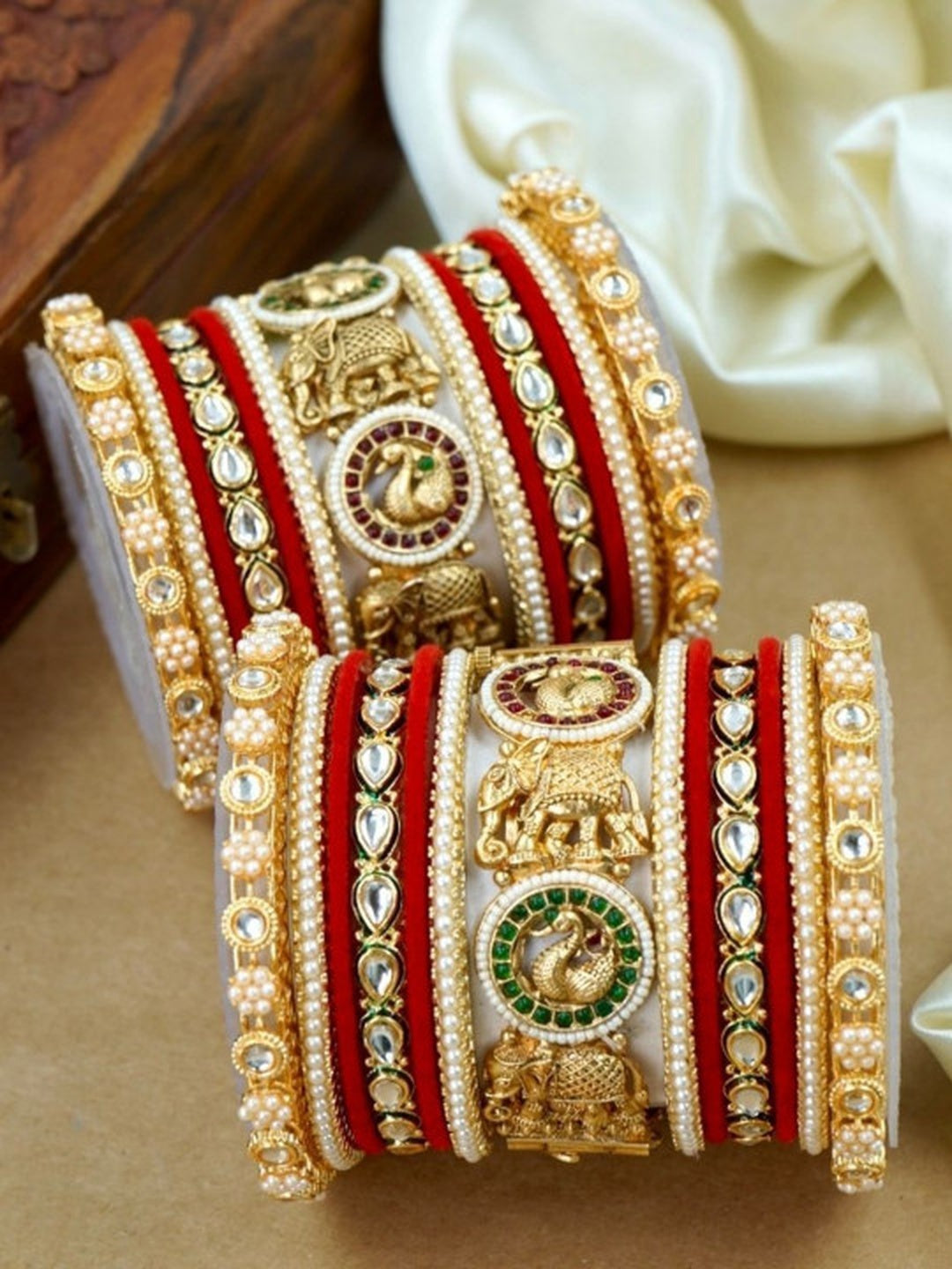Ishhaara Traditional Gold Bangles with Kundan Stones - A pair of intricately designed gold bangles adorned with kundan stones and red velvet accents.
