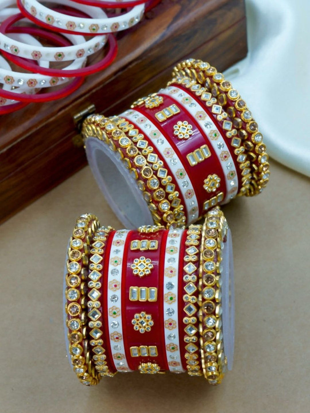 Ishhaara Traditional Red Kundan Bangle Set - a close-up view of intricately designed red and white bangles with gold and stone embellishments